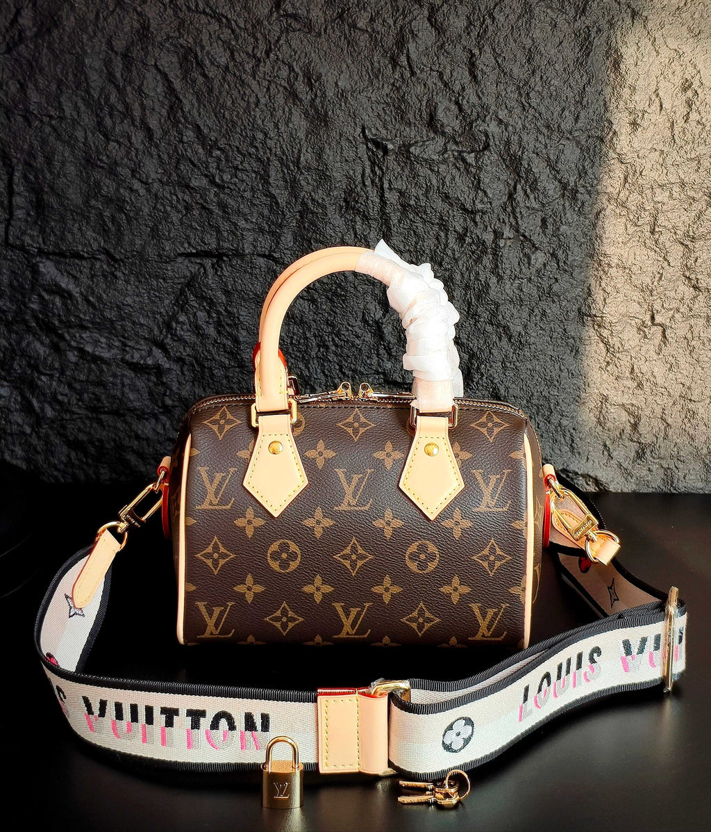 Brown monogram canvas handbag with cream leather trim, ruffled white top handle, crossbody strap