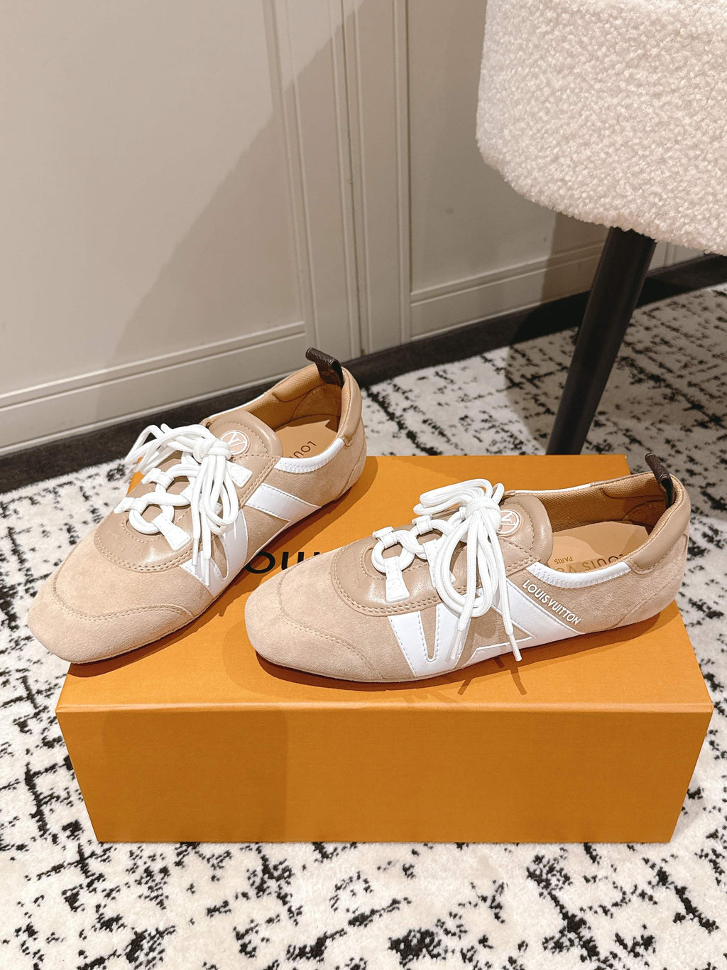 Beige suede sneakers with white laces and white side stripe on tan outsole