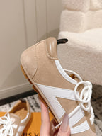 Beige suede high-top sneakers with white lace-up front and side panel overlay