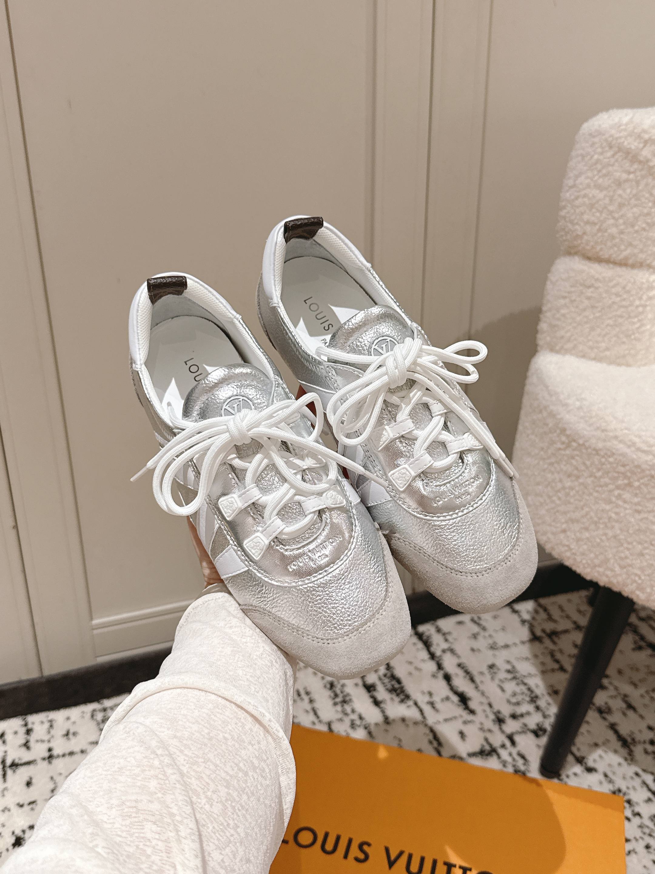 Louis Vuitton low-top sneakers in metallic silver with white lace-up ties