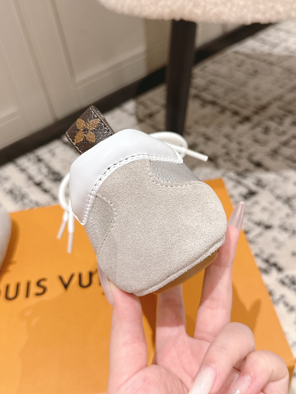Louis Vuitton metallic silver low-top sneakers showing back heel and top view