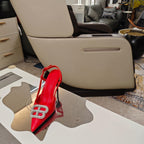 Red high-heel sandals with jeweled toe buckle, side view