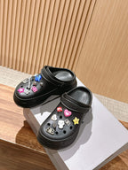 Balenciaga black clog sandals with charm accents on side, open heel and thick sole