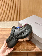 Balenciaga black clog sandals with layered thick sole and charm-studded strap