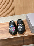 Balenciaga black clog sandals with colorful charm decorations, perforated top and strap