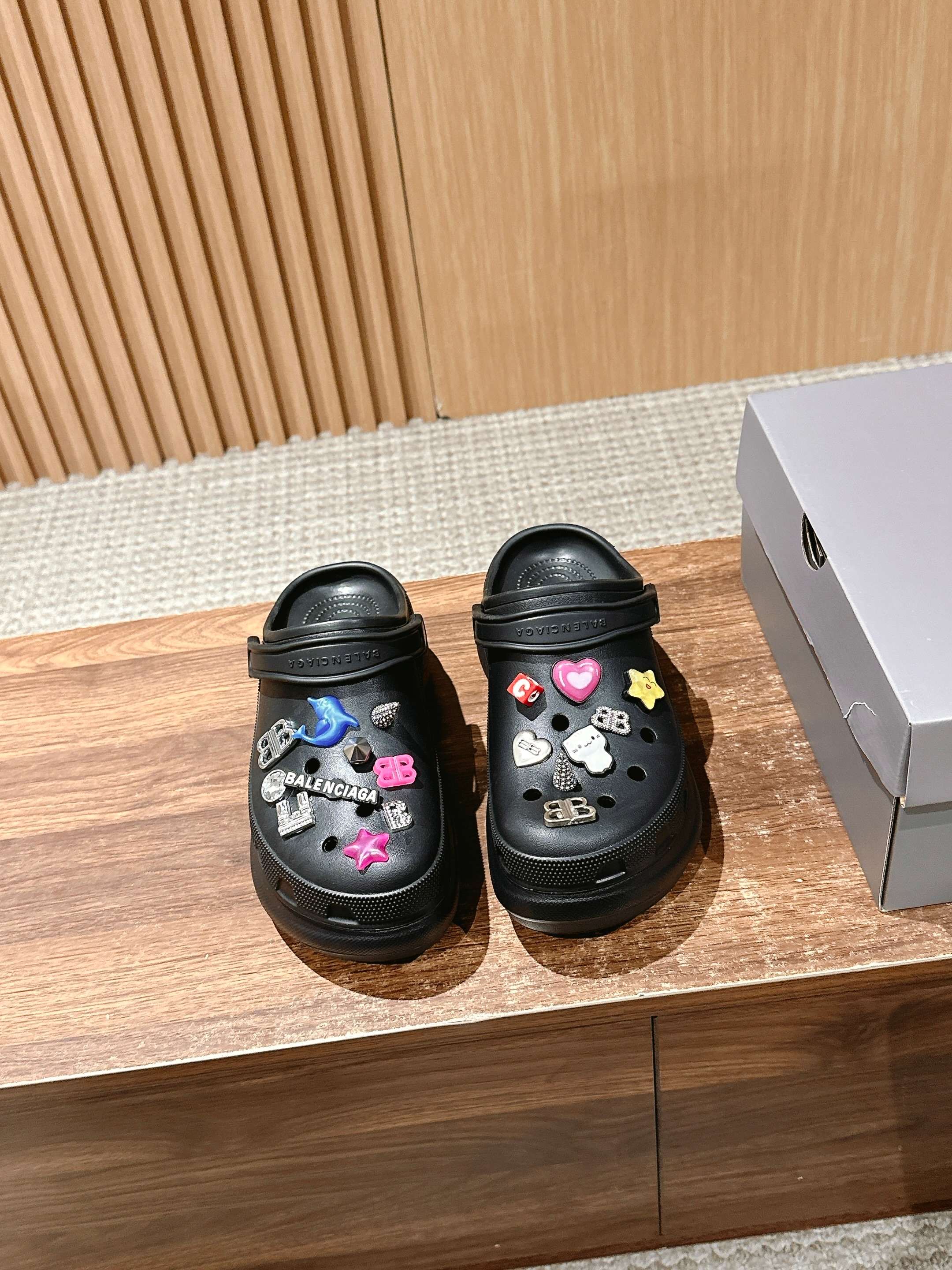 Balenciaga black clog sandals with colorful charm decorations, perforated top and strap
