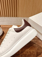 Two-tone low-top sneakers, white leather body with brown collar panel and lace-up
