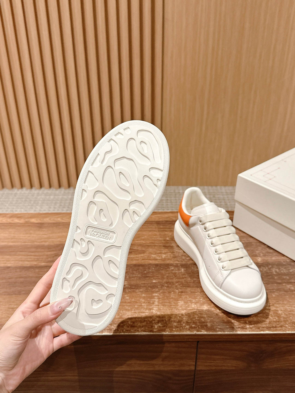 Shoe outsole and matching white sneaker with orange collar trim