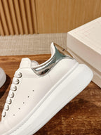 Alexander McQueen white leather sneakers with silver-trimmed collar and lace-up laces