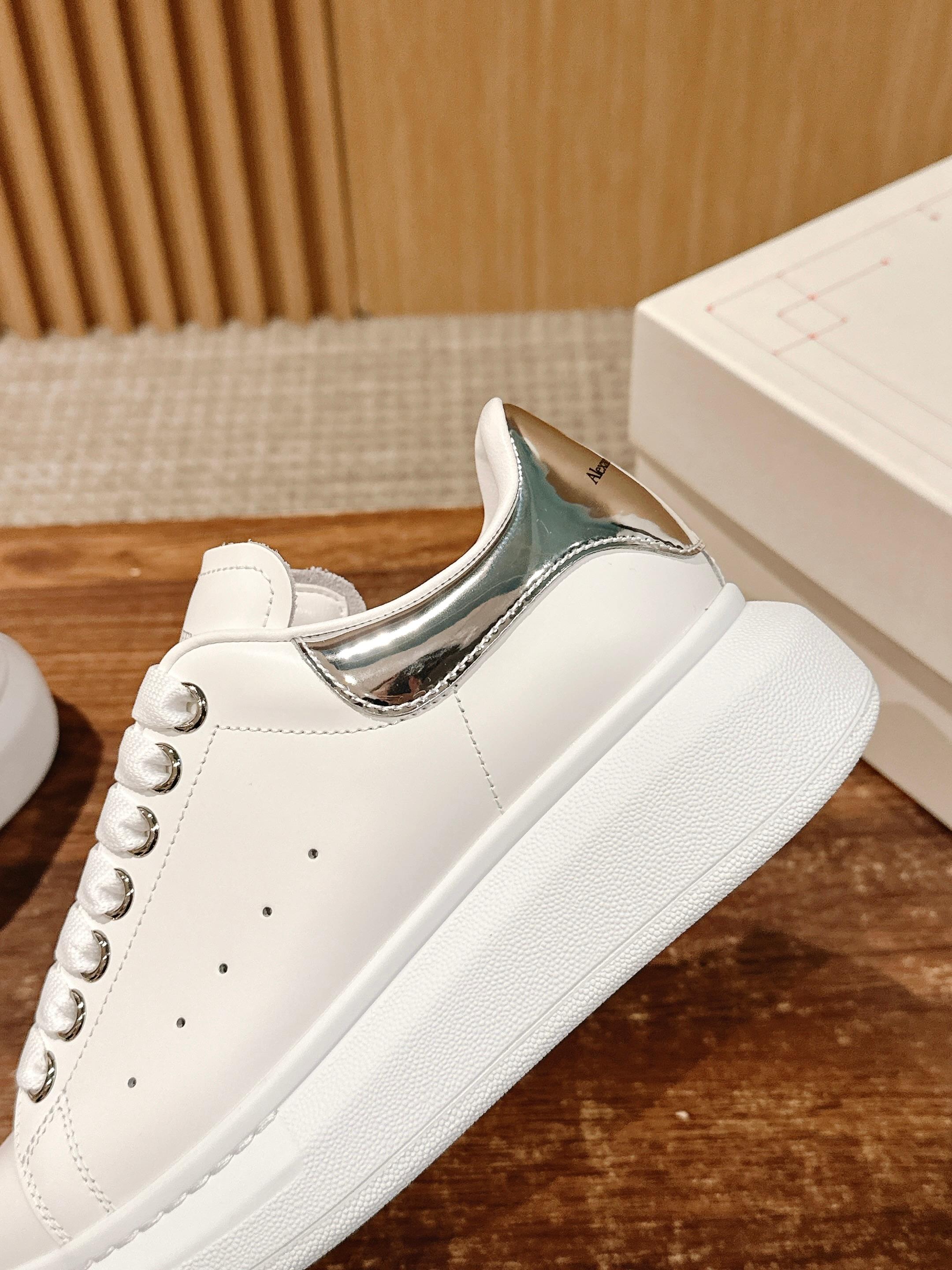 Alexander McQueen white leather sneakers with silver-trimmed collar and lace-up laces