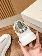 Alexander McQueen white leather sneaker with metallic heel lining and lace closure