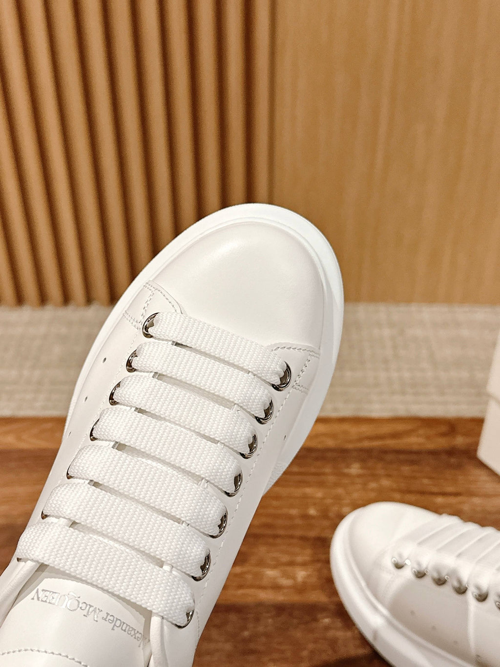 Alexander McQueen white sneaker toe with lace eyelets and smooth leather upper