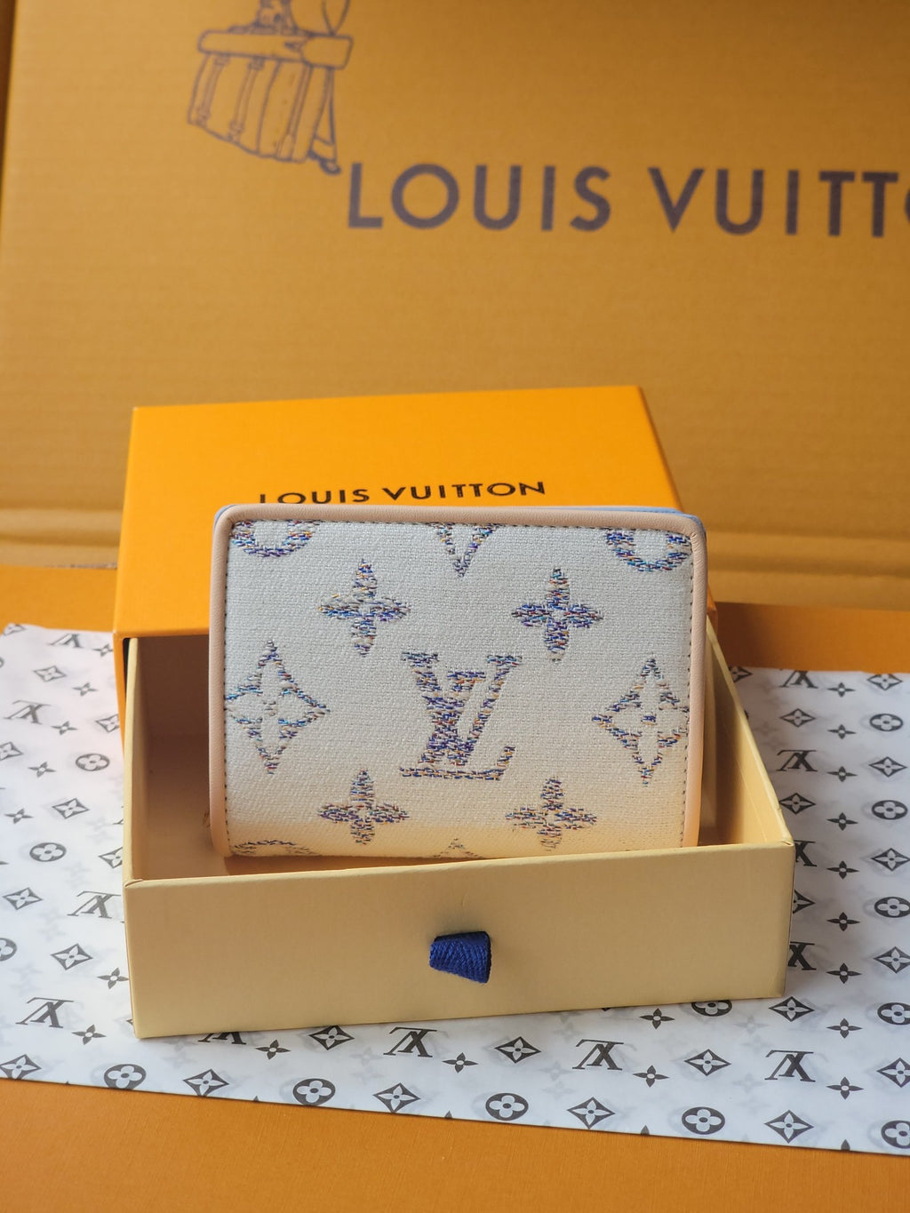 Light blue mini wallet with allover blue patterned fabric and compact foldover shape