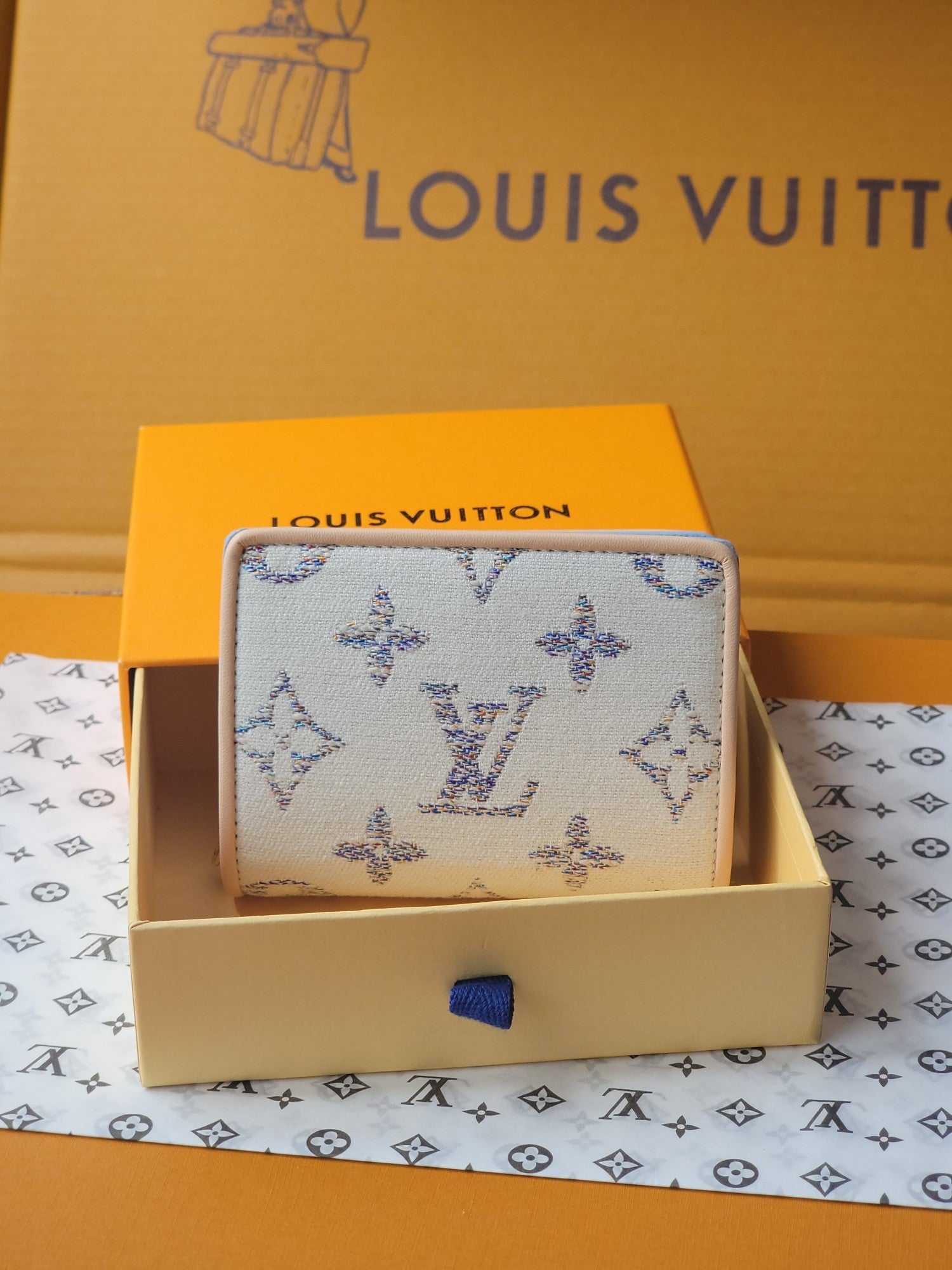 Light blue mini wallet with allover blue patterned fabric and compact foldover shape