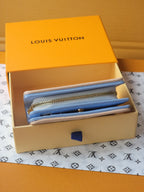 Light blue mini wallet pouch with gold zipper and interior card slots