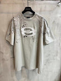 Light heather gray short-sleeve T-shirt with large oval logo graphic and speckle print