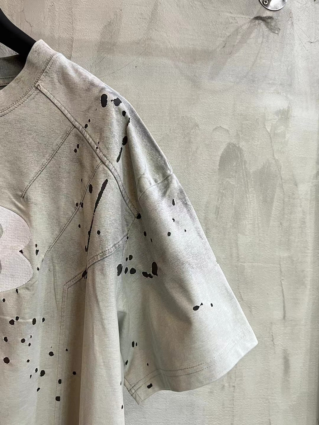 Light gray Balenciaga short-sleeve T-shirt with speckled splatter print on sleeve