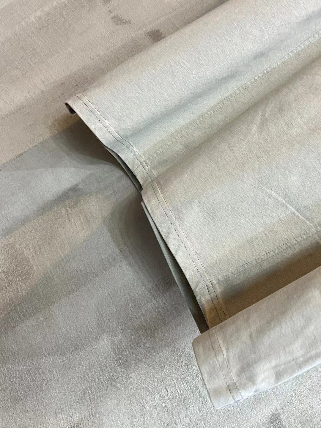 Light heather gray folded short-sleeve T-shirt showing straight hem and side seam