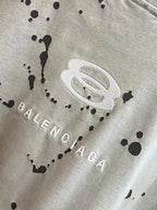 Light gray Balenciaga graphic T-shirt with BALENCIAGA text and splatter pattern