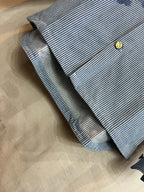 Long-sleeve shirt sleeve cuff in light blue and white stripes with gold-tone button