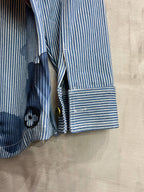 Long-sleeve shirt sleeve and cuff detail in light blue stripes with stacked button placket
