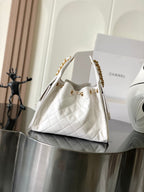 White quilted leather Chanel handbag with gold chain strap and rounded top handles