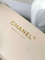 White leather Chanel logo label on edge seam