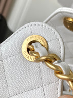 White leather bag with round gold-tone logo and interlocking chain detail
