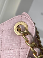 Pink quilted leather Chanel bag hardware with round turn-lock logo plate