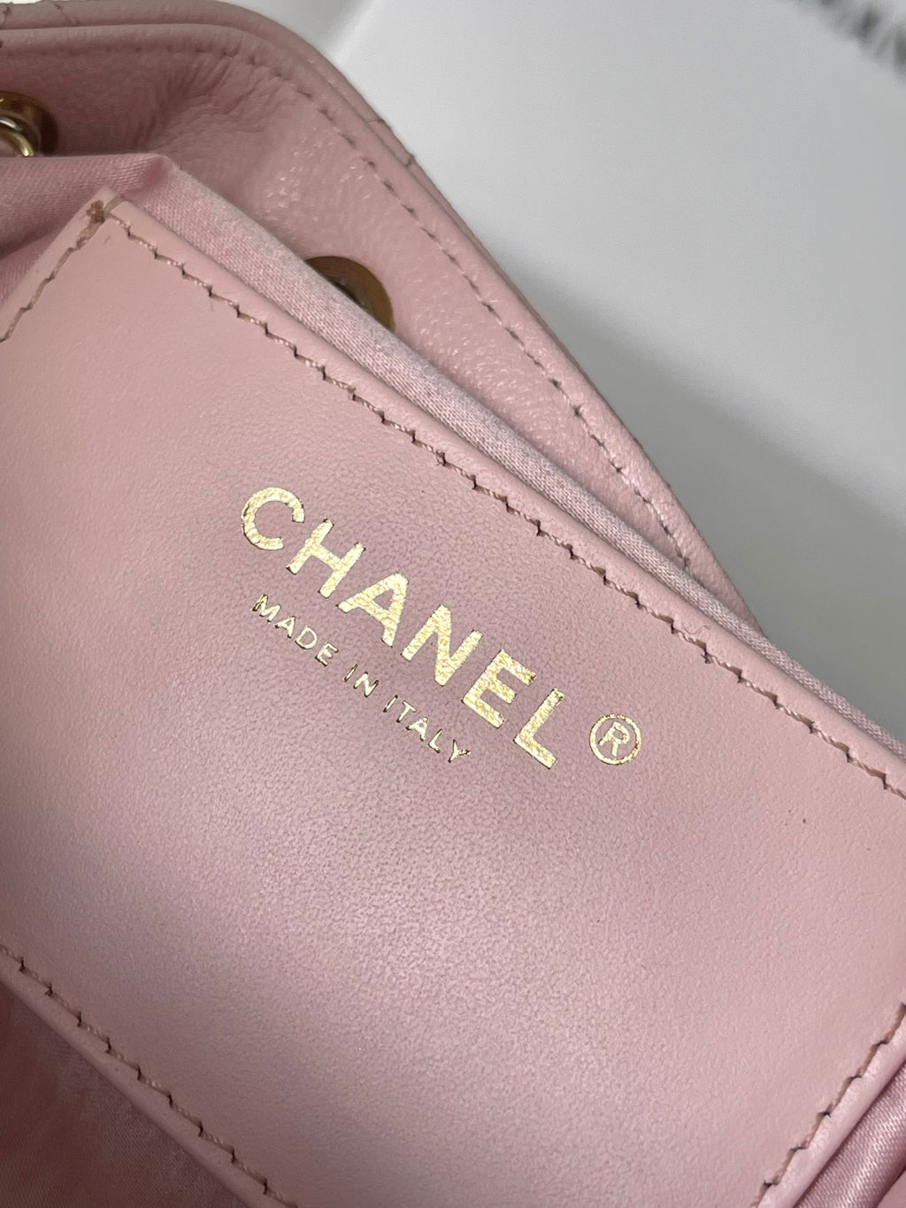 Pink leather Chanel label with CHANEL and MADE IN ITALY text