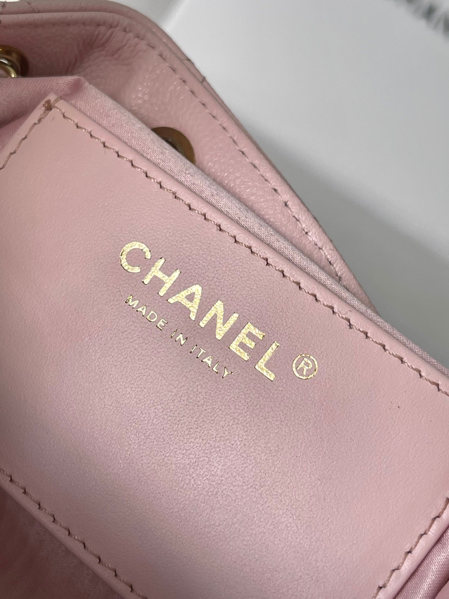 Pink leather Chanel label with CHANEL and MADE IN ITALY text