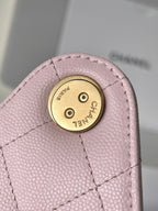 Pink leather Chanel bag turn-lock plate with CHANEL text
