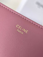 Pink leather Celine bag close-up of gold stamped CELINE PARIS text