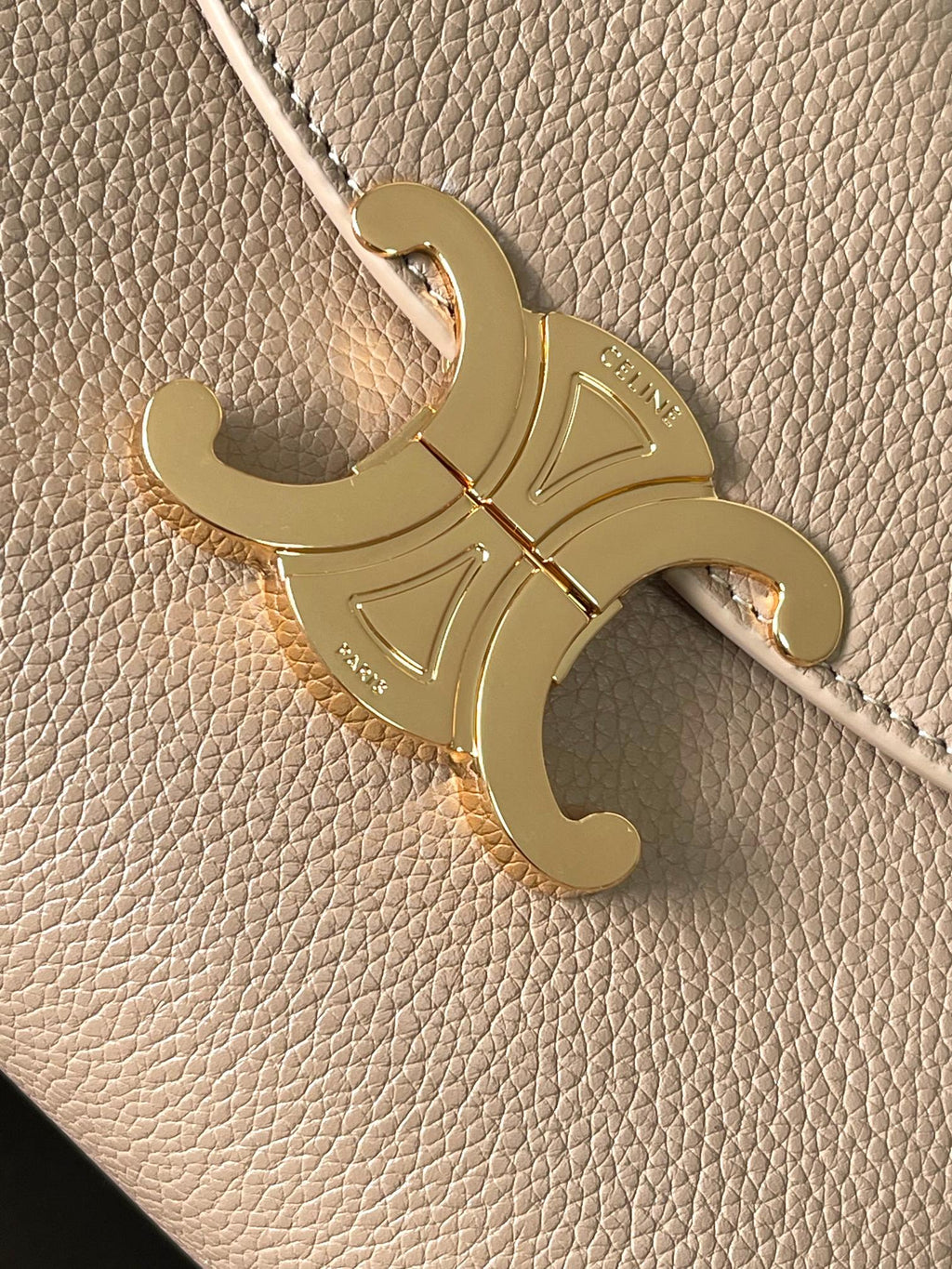 Celine engraved gold-tone logo charm on beige textured leather bag