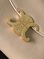 Celine engraved gold-tone logo charm on beige textured leather bag