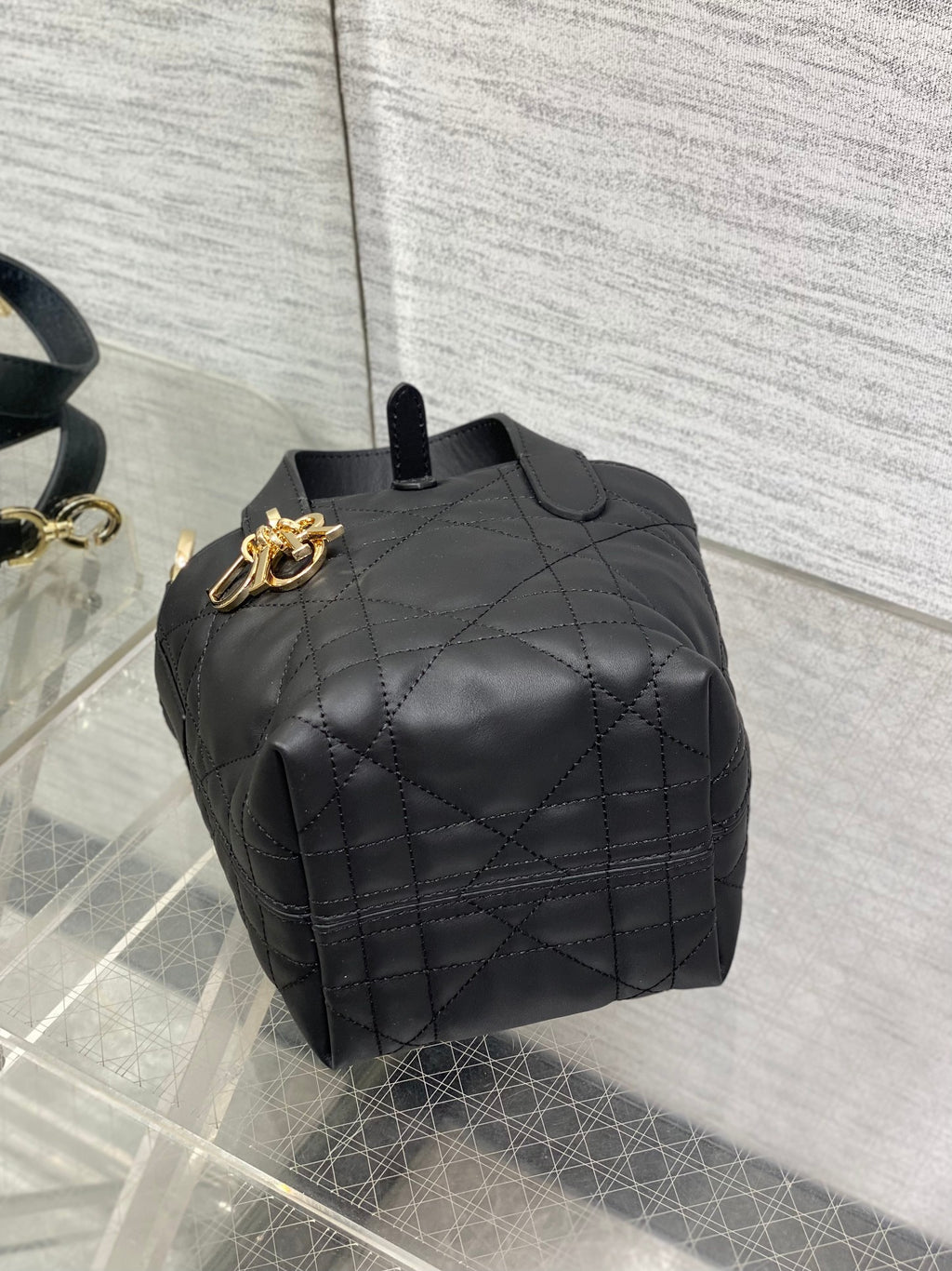 Black quilted Dior mini tote with top handle and gold-tone pull-ring hardware