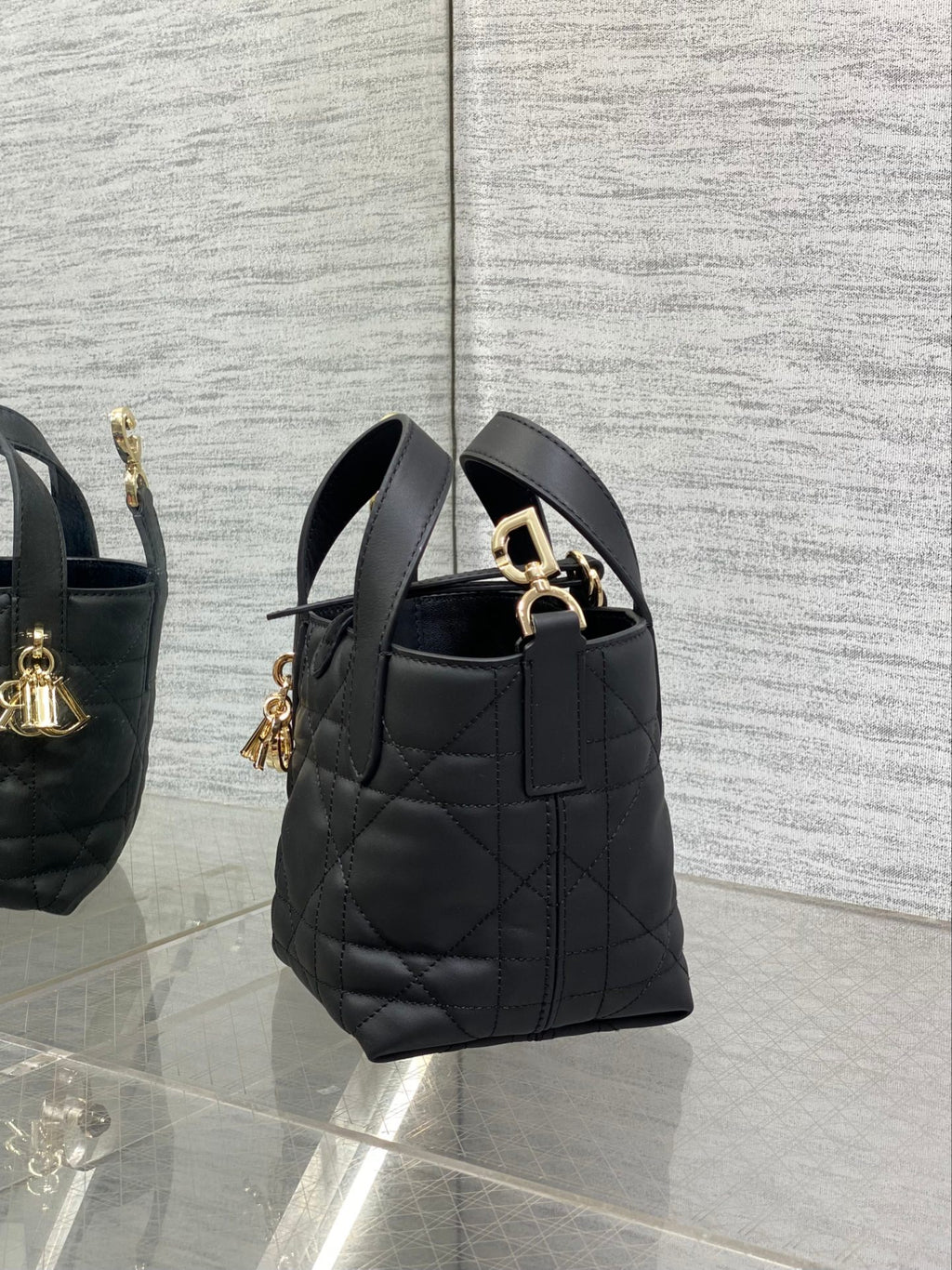 Black quilted Dior mini tote bag with short handles and gold-tone side hardware