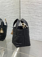 Black quilted Dior mini tote bag with short handles and gold-tone side hardware