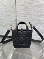 Black quilted leather Dior mini tote with shoulder strap and gold-tone clasp detail