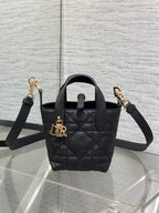 Black quilted leather Dior mini tote bag with top handle and gold-tone hardware