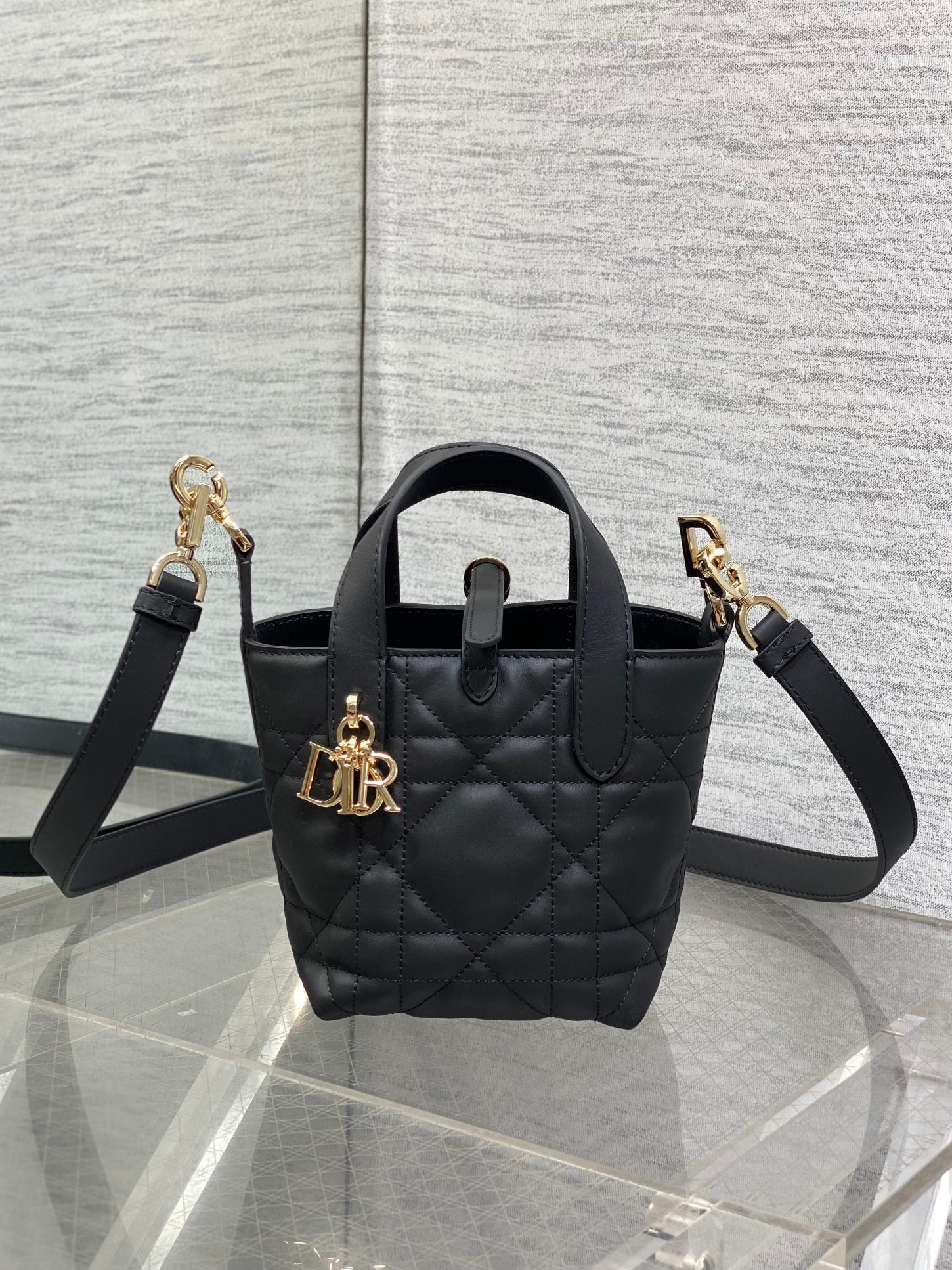 Black quilted leather Dior mini tote bag with top handle and gold-tone hardware
