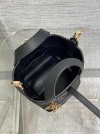 Black Dior mini tote interior with gray strap and gold-tone buckle closure