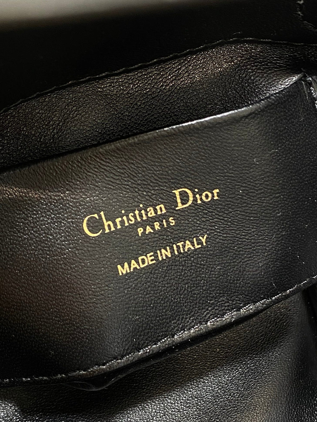 Black leather Dior logo stamp reading "Christian Dior" and "MADE IN ITALY"