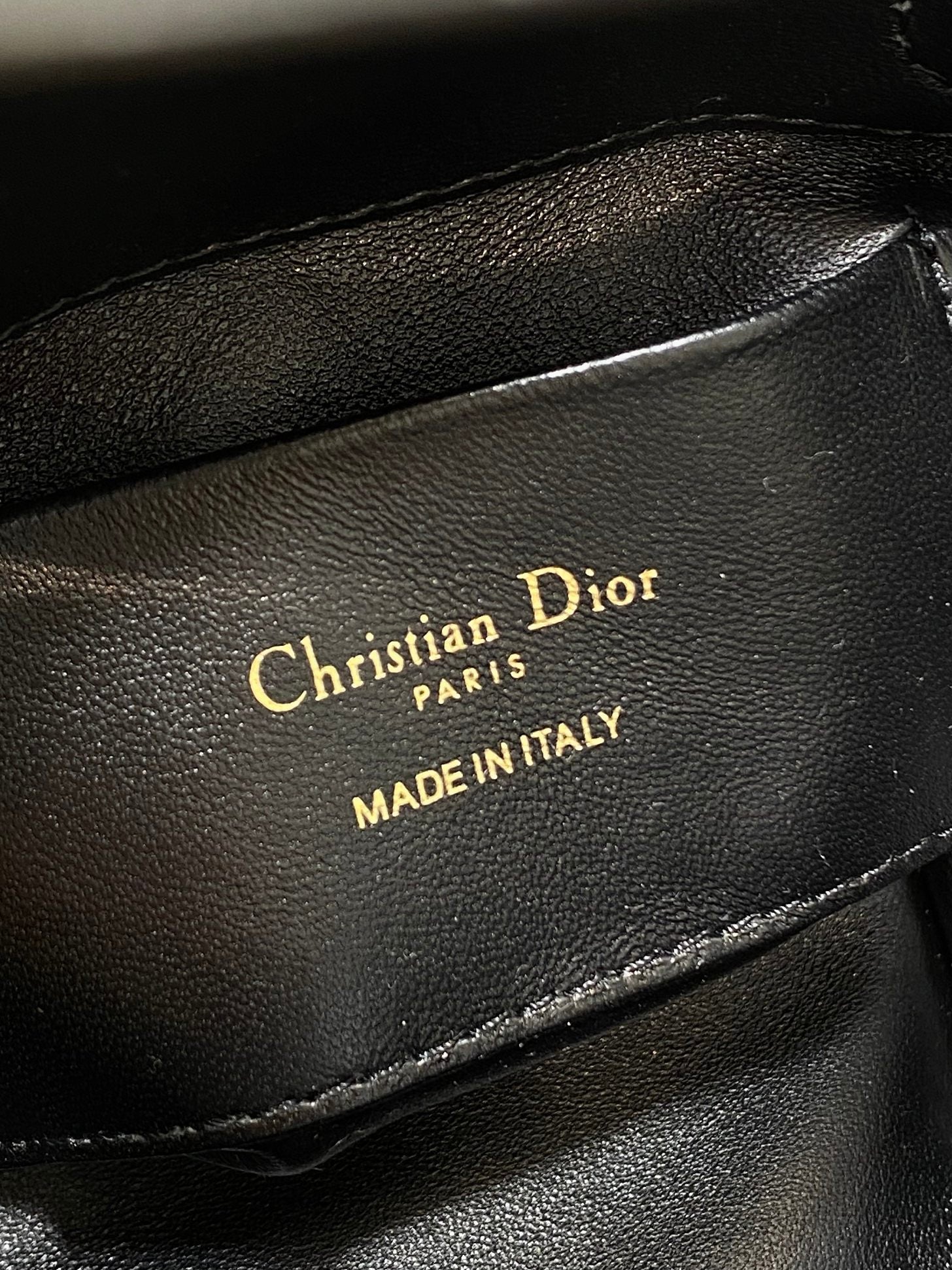 Black leather Dior logo stamp reading "Christian Dior" and "MADE IN ITALY"
