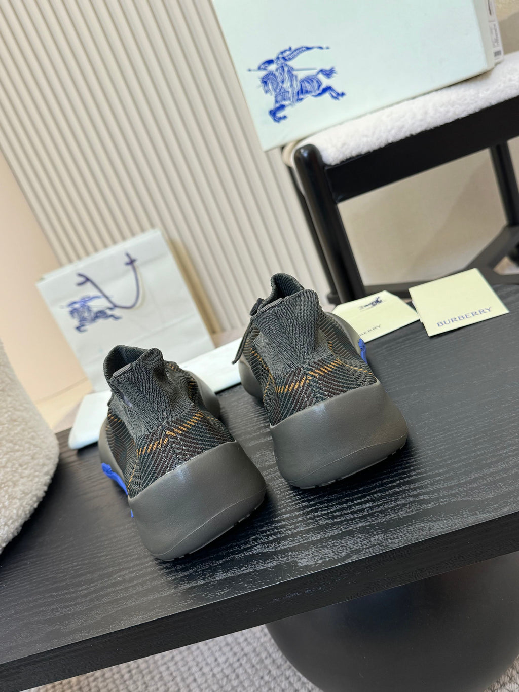 Burberry knit sneakers with blue heel accents, rear view