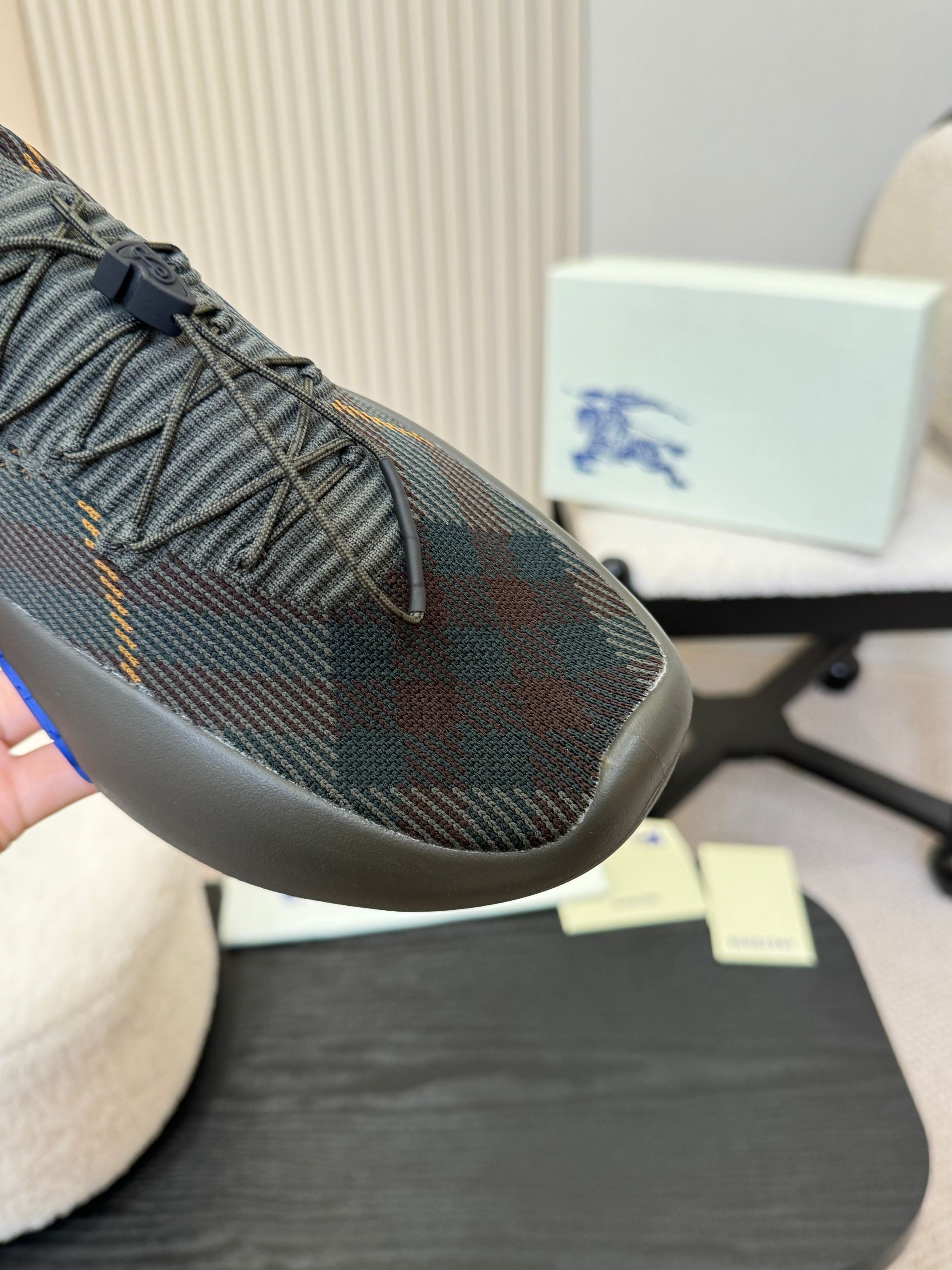 Burberry knit sneaker toe with lace-up detail and blue sole stripe