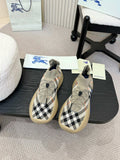 Beige slip-on sneaker with black and white check knit and blue outsole detail.