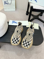 Beige slip-on sneaker with black and white check knit and blue outsole detail.