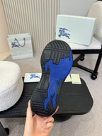 Shoe outsole view: black sole with blue traction pattern
