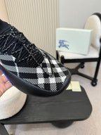 Close-up of black-and-white check slip-on sneaker upper with blue sole edge